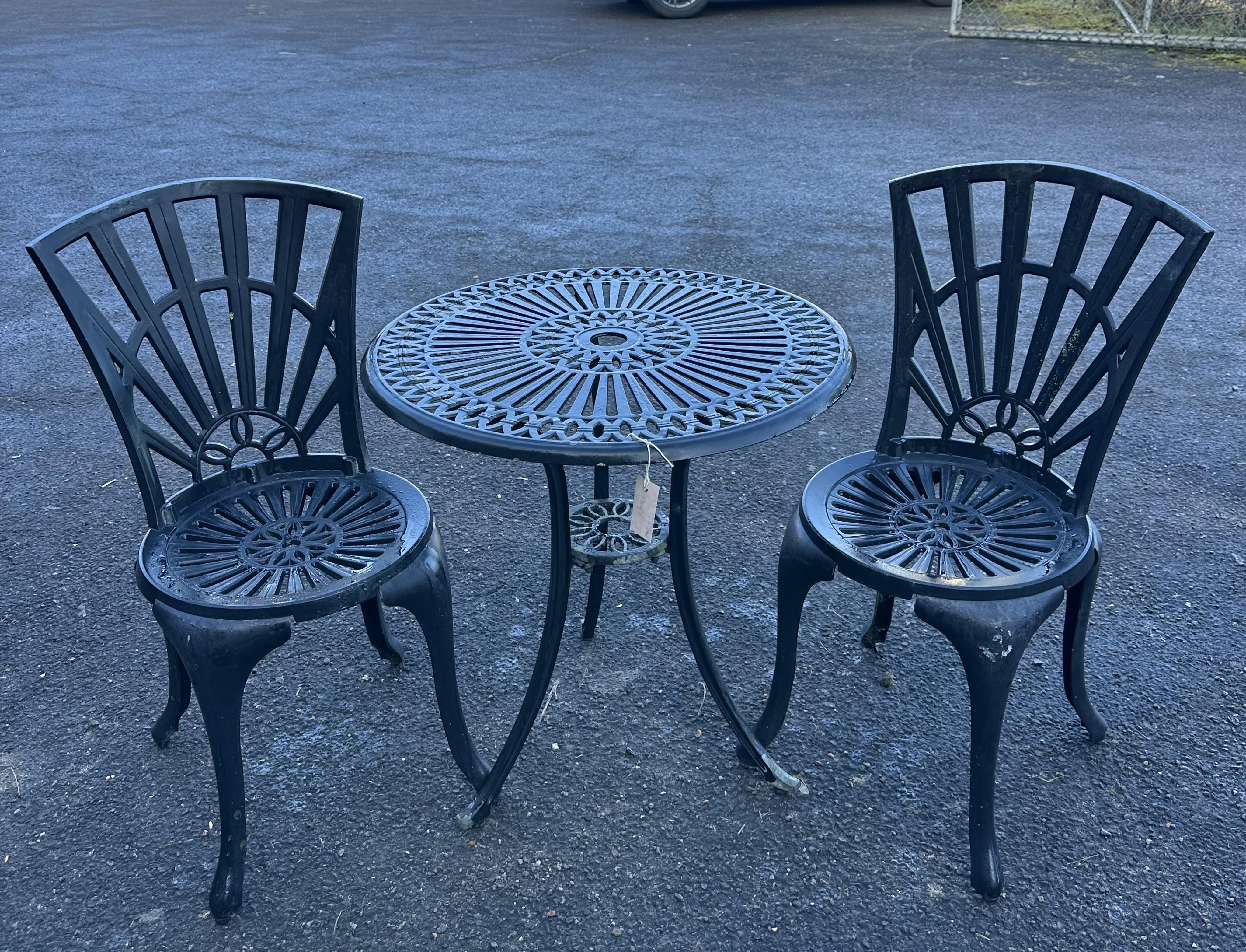 An aluminium garden table, diameter 65cm and a pair of chairs. Condition - poor